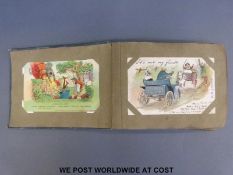 An early 20th century album of postcards to include humorous,