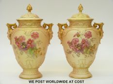 Royal Worcester pair of pedestal lidded vases with twin mask handles decorated with flowers,
