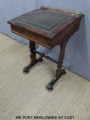 A 19thC leather inset rosewood desk with fitted interior and brass galleried top,
