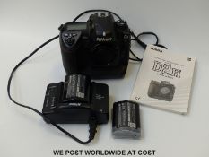 A Nikon D2H SR camera with battery charger,