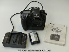 A Nikon D2X SLR camera with battery charger,