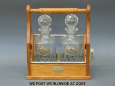 An oak two-bottle tantalus (W28cm)