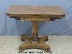 A 19thC rosewood games table supported by a moulded tapering column raised on a quatrefoil base and