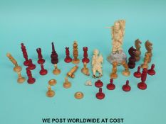 A carved bone part chess set and two further carved figures