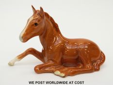 Beswick chestnut foal lying