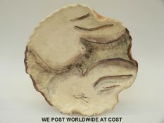 A studio pottery charger decorated with doves,