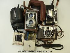 A Ricoh Flex modeI VII cased TLR camera together with other vintage cameras,