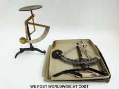 A boxed swinging weight type scale and a further unboxed example