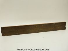 A brass faced slide rule to measure the tension of leather machinery belts