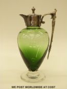 A green glass claret jug with silver plated mounts, 26cm tall.
