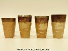 Four Doulton Lambeth salt glazed beakers including a pair with hallmarked silver mounts (tallest 12.