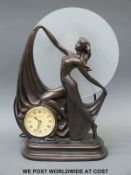 An Art Deco style figural lamp with clock insert,