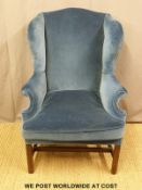 A Georgian upholstered mahogany wing-back armchair