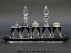 An Art Deco style glass condiment set comprising, two oil bottles and a mustard pot,