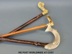 Three walking sticks including a horn handled example carved as a fish