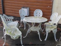 An ornate cast metal set of garden furniture including a bench raised on six legs,