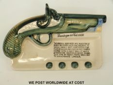 An unmarked ashtray decorated with the Derringer pistol invented by Henry Derringer in 1850 (20cm)