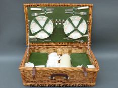 A wicker picnic hamper and fitted contents,
