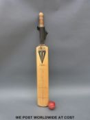 A cricket bat signed by 18 Gloucestershire CCC players together with a used match ball
