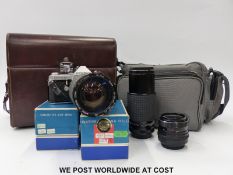 A Pentax ME super SLR camera with Vivitar 28-200mm lens, two Zeiss flektogon 2,4/35 lenses,