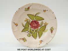 An 18th/19thC Delft charger with flower decoration and signature verso (31cm diameter)