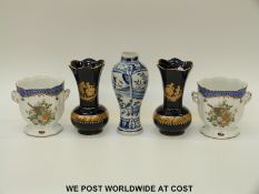A pair of transfer printed twin-handled pedestal vases,