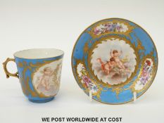 Sevres porcelain cup and saucer with cherub and flower cartouche decoration on a turquoise ground,