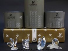 Four Swarovski animals comprising a Collectors' Society swan, a goat and two butterflies,