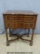 A continental breakfront chest of two drawers raised on barley twist legs united by shaped