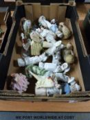 A collection of continental figures including a piano doll,