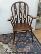A 19thC elm seated Windsor arm chair