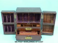 A 19thC mahogany brass-bound apothecary cabinet with fold-out doors,