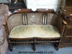 An Edwardian serpentine-fronted bergere drawing room sofa (W95cm x D46cm)