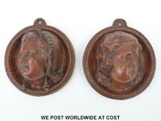 A pair of German terracotta wall plaques