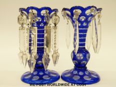 A pair of flash overlaid blue glass lustres with clear cut drops, 17cm tall.