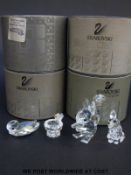 Four Swarovski animals comprising a squirrel, fox, bird on a birdbath and a duck,