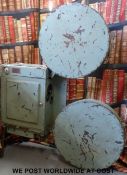 A vintage 35mm portable film or movie projector with removable film cans and extending legs,