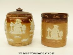 Two Doulton Lambeth tobacco jars with relief moulded decoration (tallest 14.