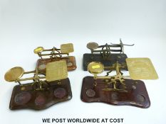 Four brass postage scales including a set marked John Heath,