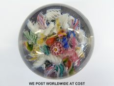 Baccarat style scrambled glass paperweight with various multi-coloured latticino tubes and central