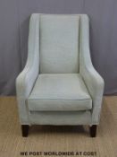 A contemporary upholstered wing back armchair