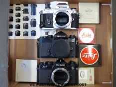 Three Nikon FG and FE SLR cameras