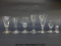 Seven Georgian and similar drinking and firing glasses some with knopped stems and some with cut