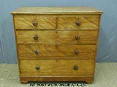 A Victorian satinwood chest of two over three graduated drawers with turned knobs and raised on bun