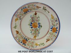 A Delft charger decorated with flowers,
