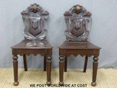 A pair of Victorian mahogany shield back chairs with shaped aprons raised on moulded octagonal