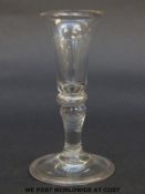 A Georgian gin glass with elongated trumpet bowl over cushion knop and inverted baluster stem