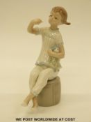 A Lladro figure of a girl with a doll