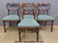A set of four Victorian upholstered rosewood balloon back chairs with moulded supports raised on