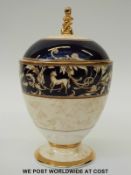 Wedgwood Cornucopia pedestal lidded vase with gilded figural finial (23cm tall)